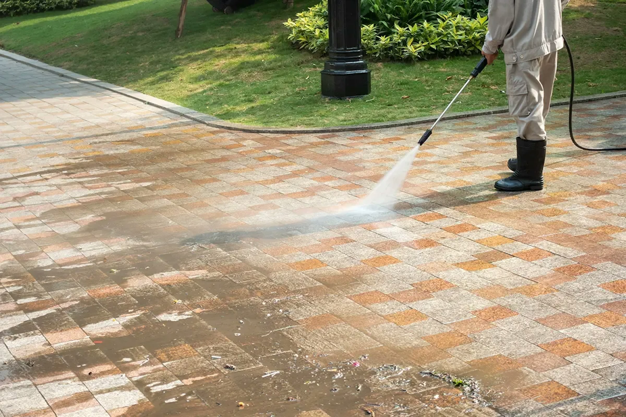 Jani-King Blast Off water blasting pavers on a commercial pathway